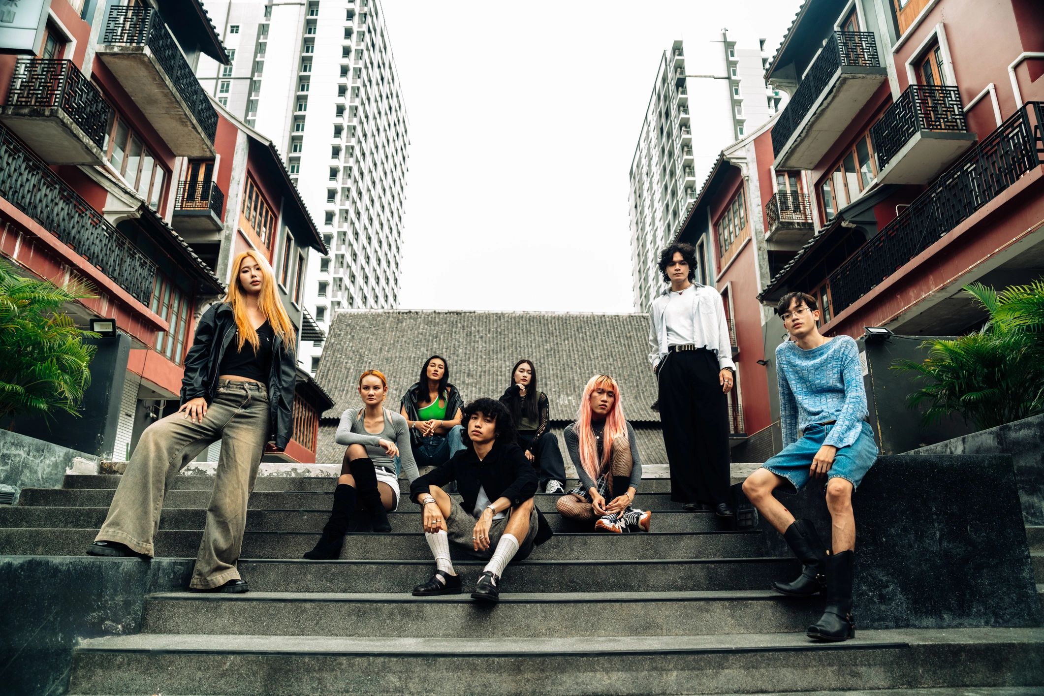 Group of stylish young adults gathered on city steps