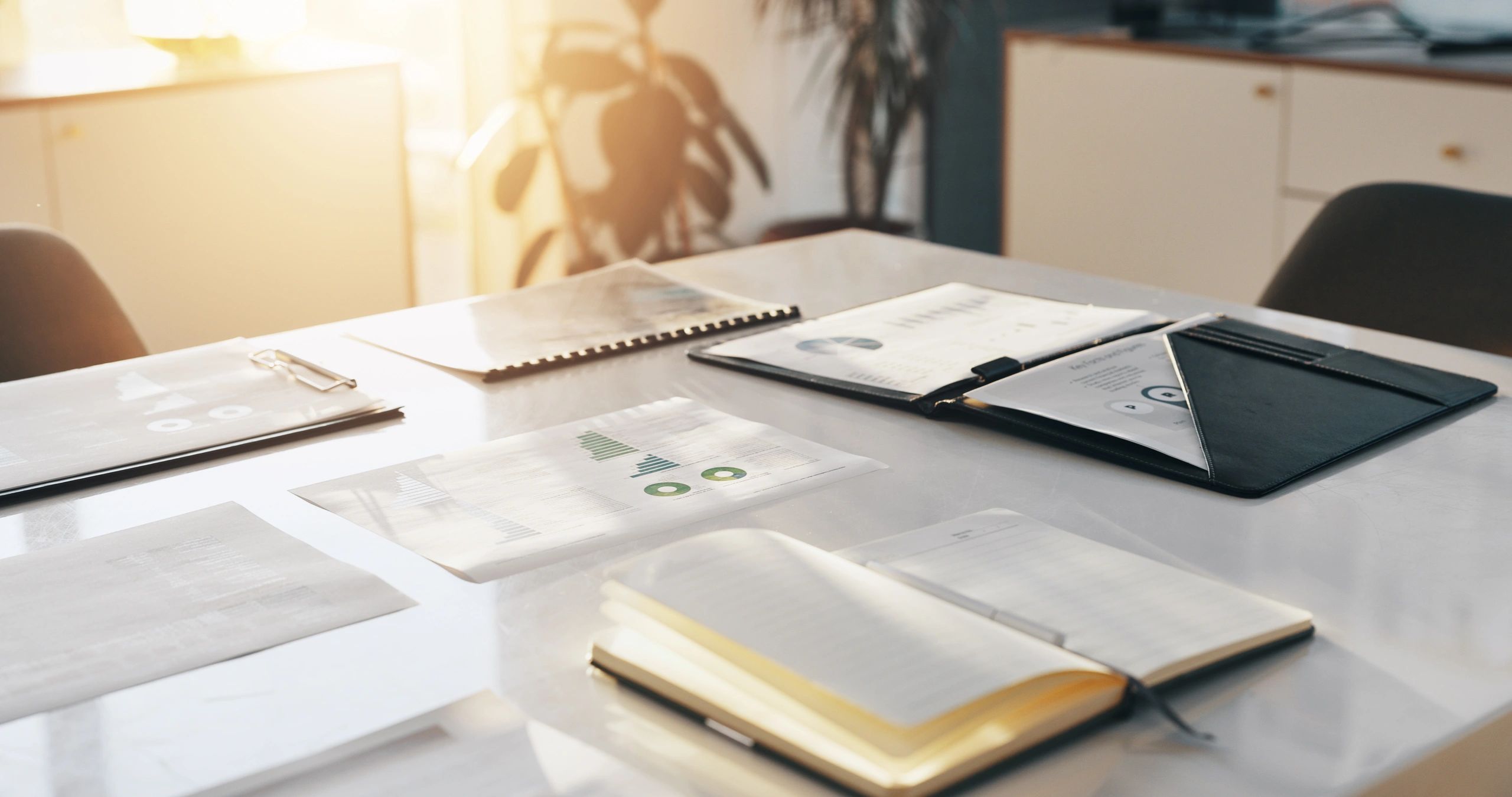 Research papers and notebook arranged on a desk